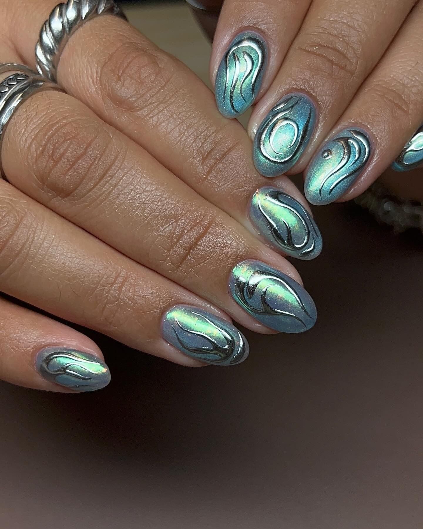 An image of blue chrome nails.