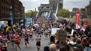 Runners turning right after crossing Tower Bridge during the London Marathon in 2024
