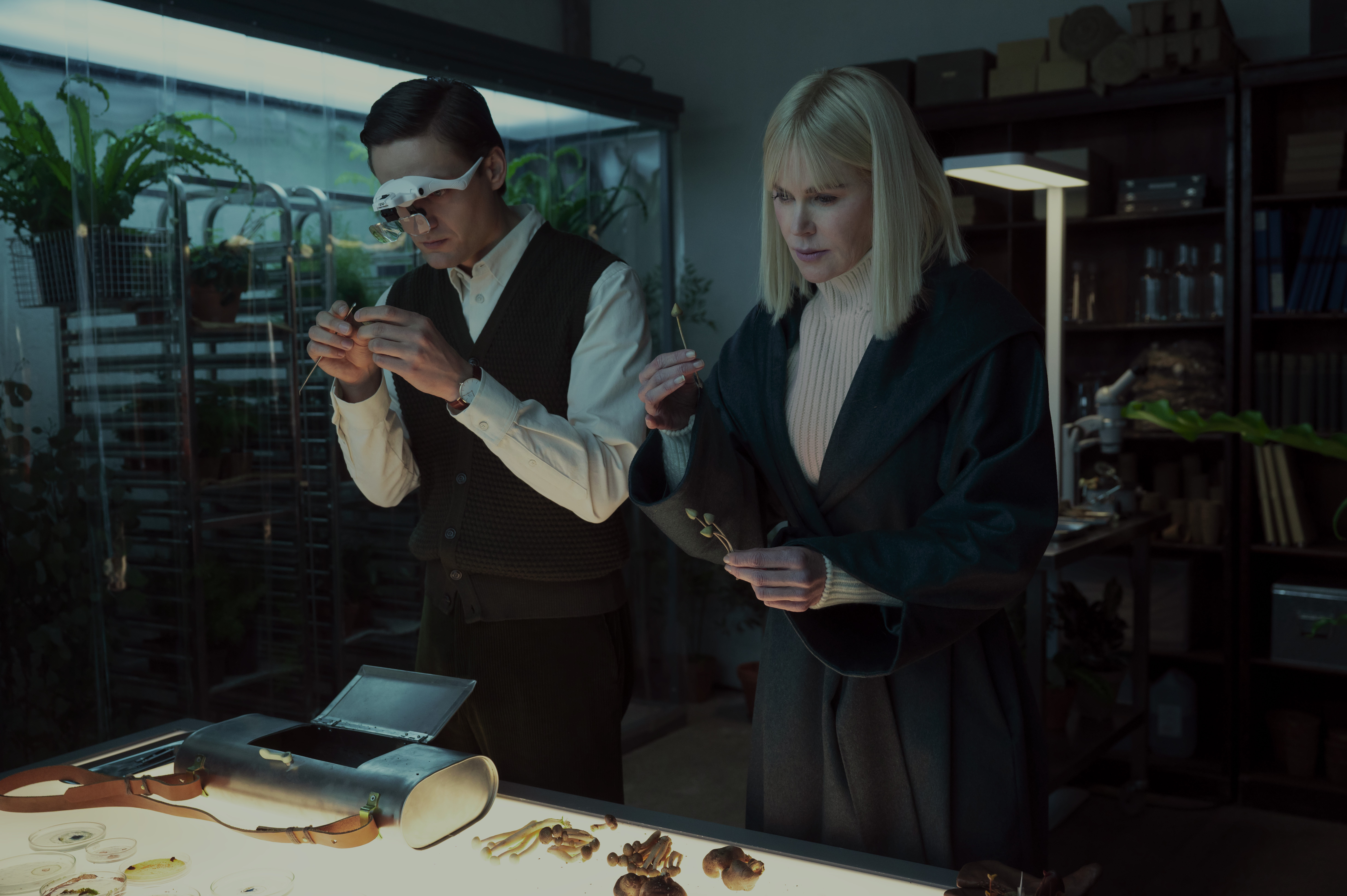 Lucas Englander as Martin wearing goggles and examining something with nicole kidman as masha in nine perfect strangers season 2