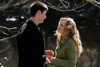 James Lafferty and Bethany Joy Lenz as nathan and haley standing under a tree in one tree hill