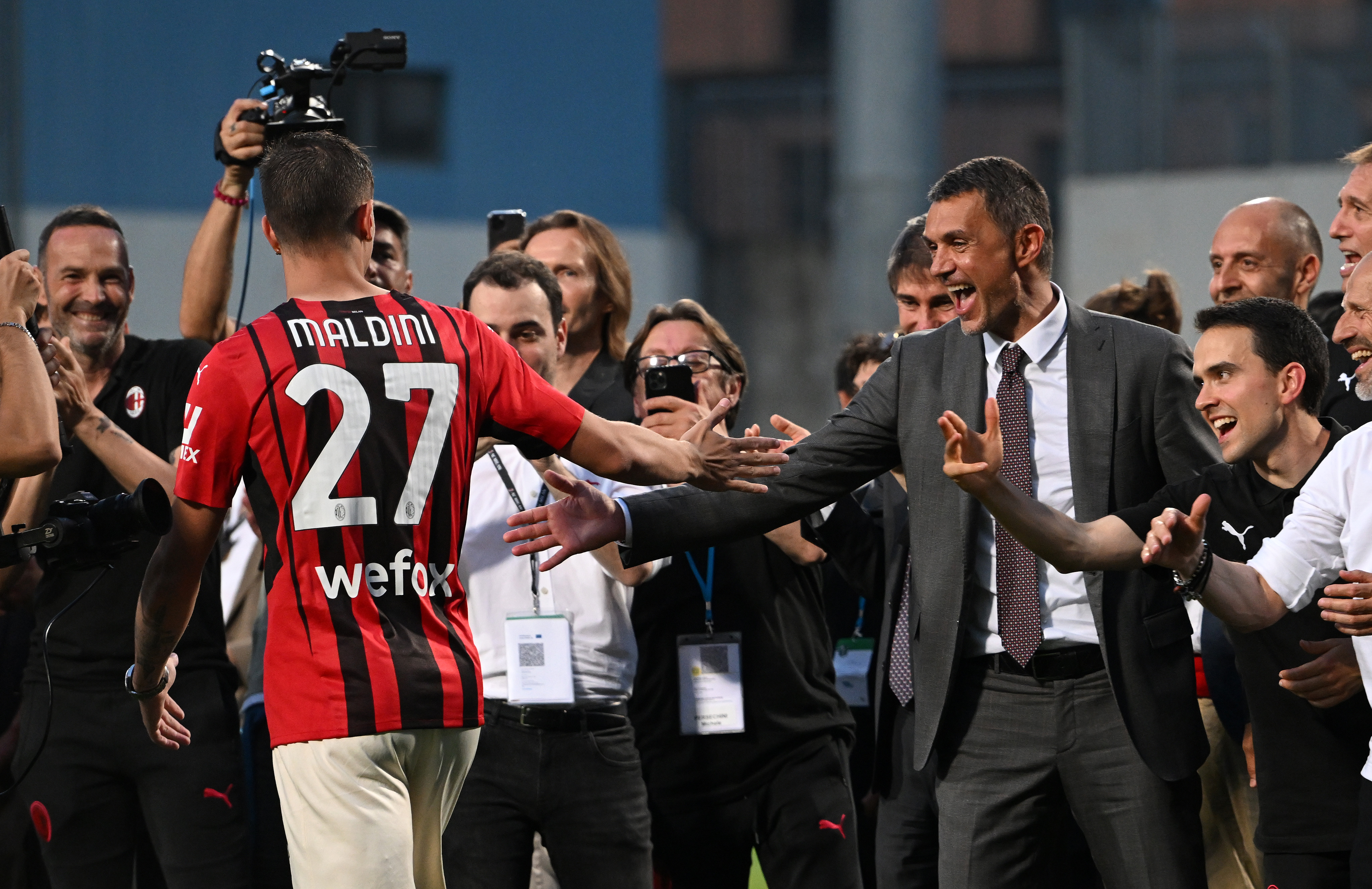 AC Milan technical director Paolo Maldini claps hands with son Daniel Maldini following a game against Sassuolo after the club's Serie A title win in May 2022.