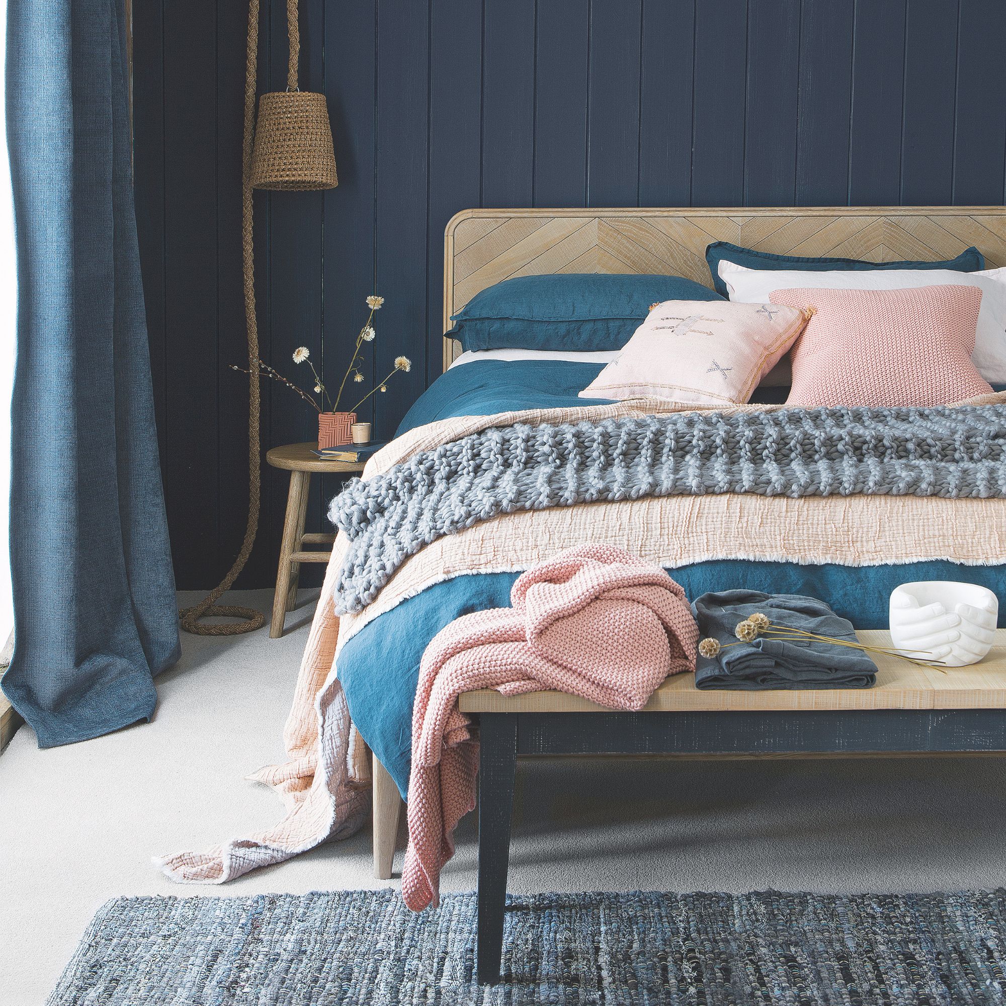 A navy bedroom with wooden details
