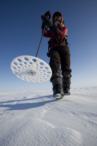 Melinda Webster, a graduate student at the University of Washington, uses a probe to measure the Arctic snow thickness near Barrow, Alaska in 2012.