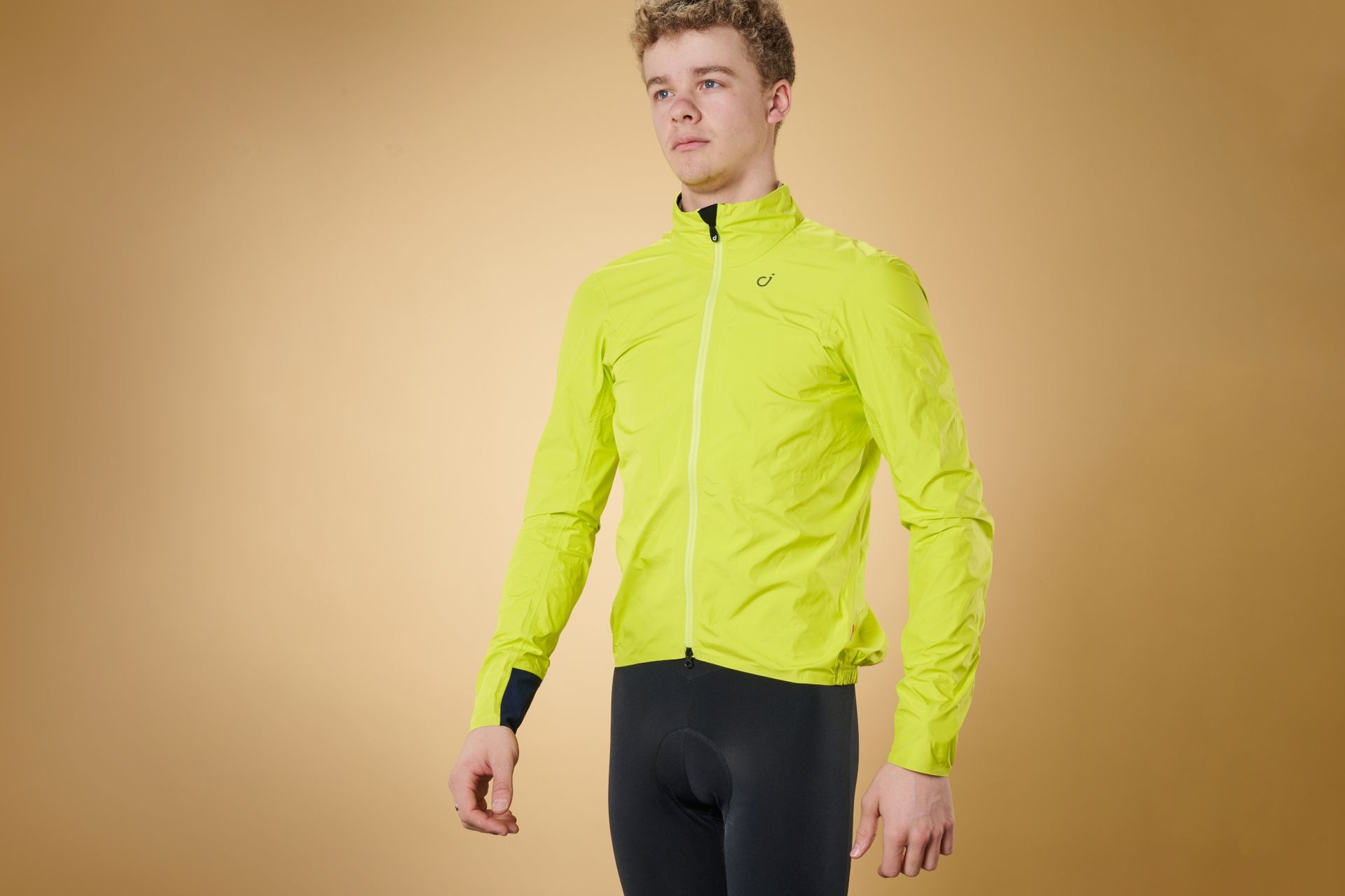 Man wearing Velocio Ultralight rain jacket in yellow