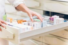 Pharmacist open a drawer