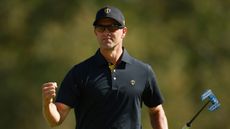 Adam Scott celebrates holing a putt in the Presidents Cup Friday foursomes