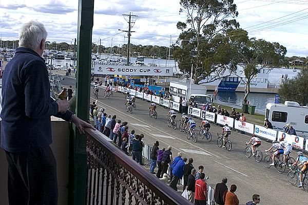 Grandstand view: A Hotel patron enjoys a beer from the balcony as the tour speeds by in Paynesville.