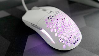 A Glorious Model O Eternal gaming mouse on a mouse mat with the lighting enabled.