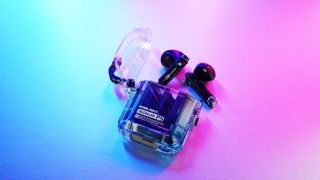 GravaStar Sirius P5 earbuds and case on multi-colored background
