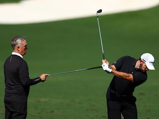 Patrick Cantlay practicing on the range with his coach