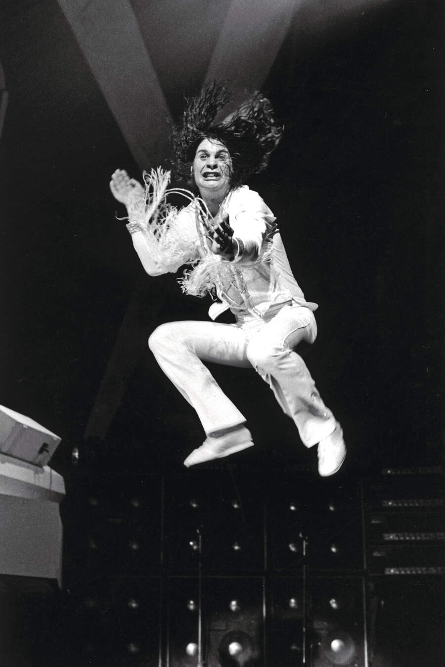 Ozzy Osbourne onstage, leaping into the air
