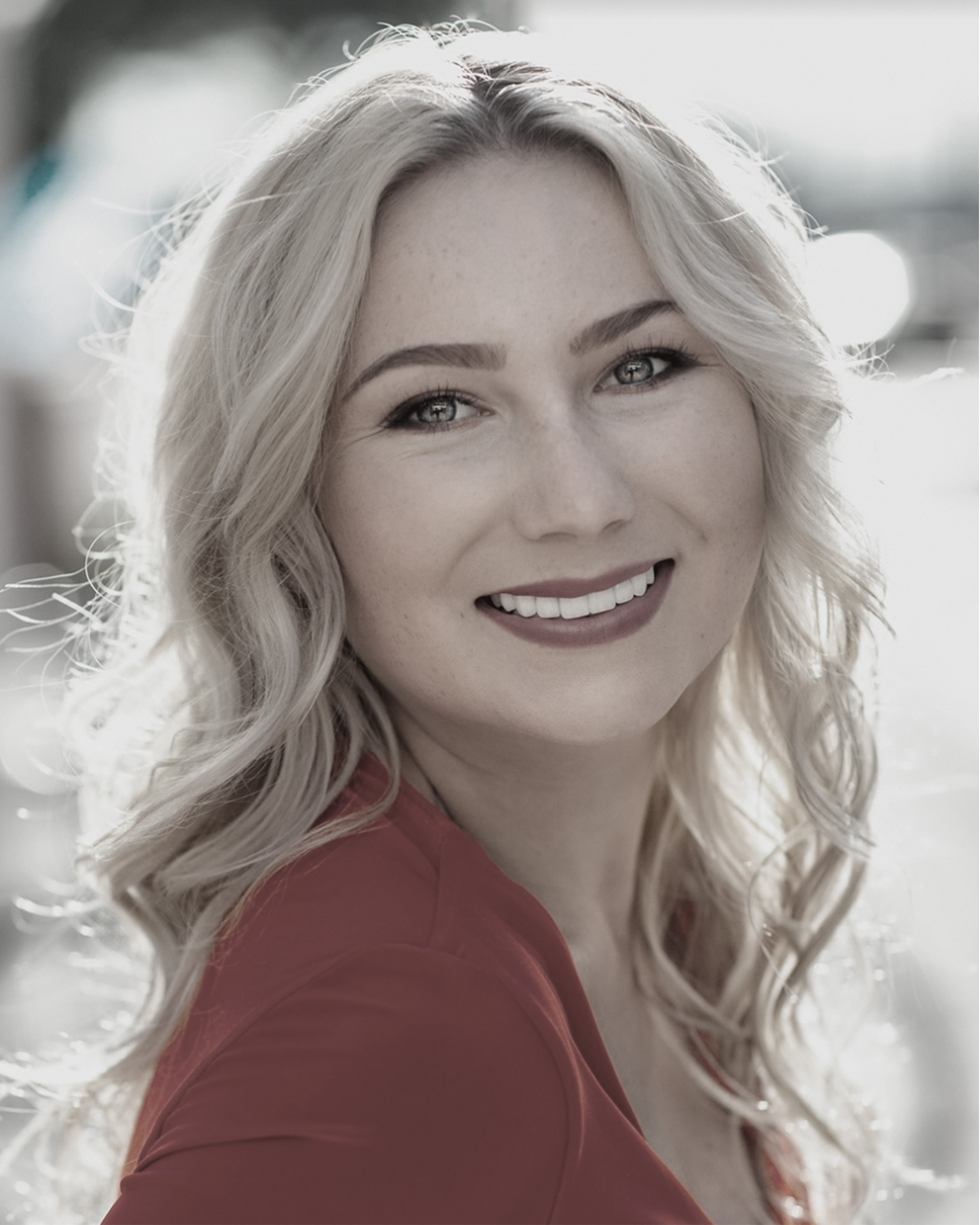 Keely Cat-Wells smiling, wearing a red top.