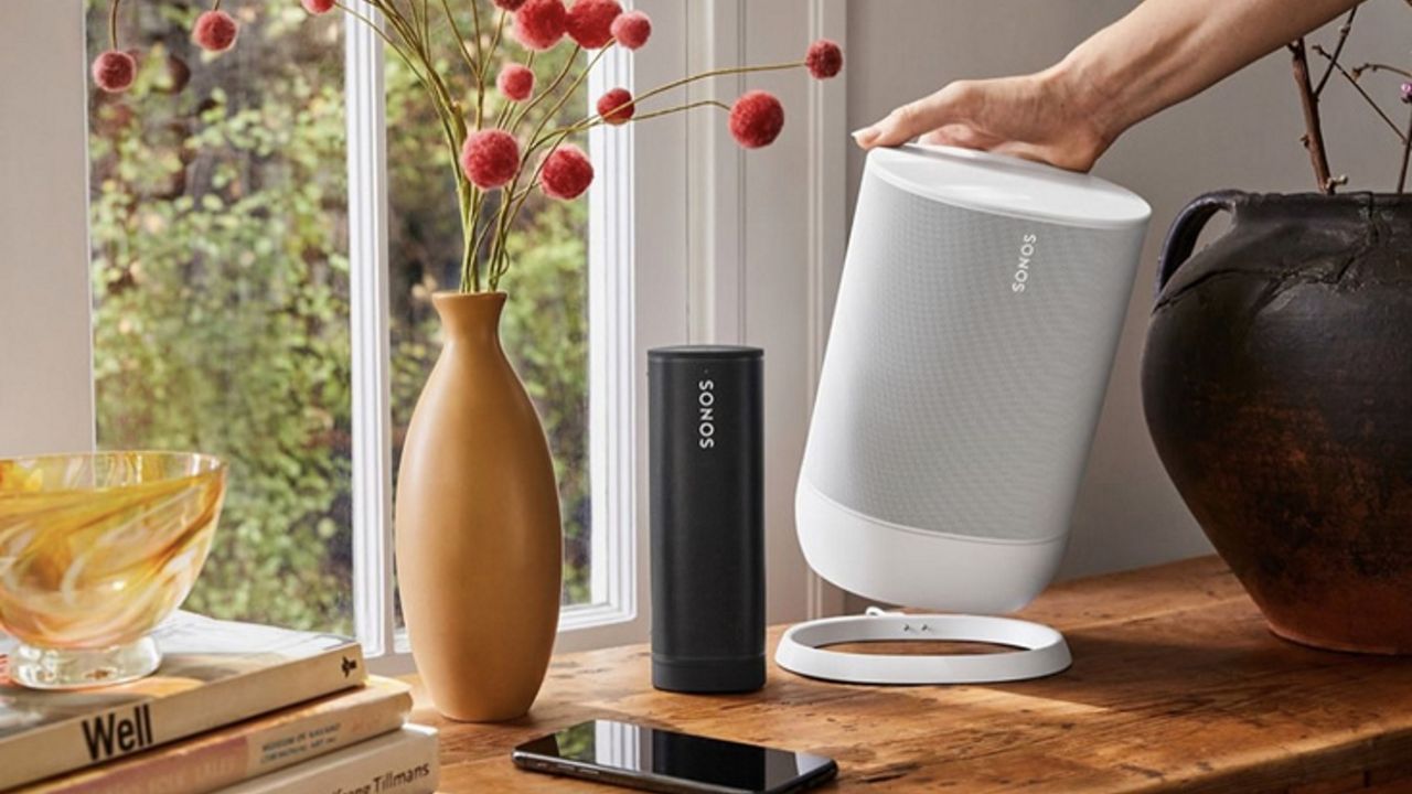 Sonos Roam and Sonos Move next to each other on wooden sideboard