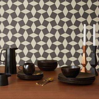 dining room with black dinnerware and grey and white geometric pattern walls