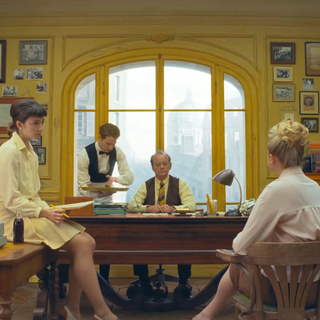 A still from Wes Anderson’s The French Dispatch, in which the journalists gather in their editor’s citron-yellow office.