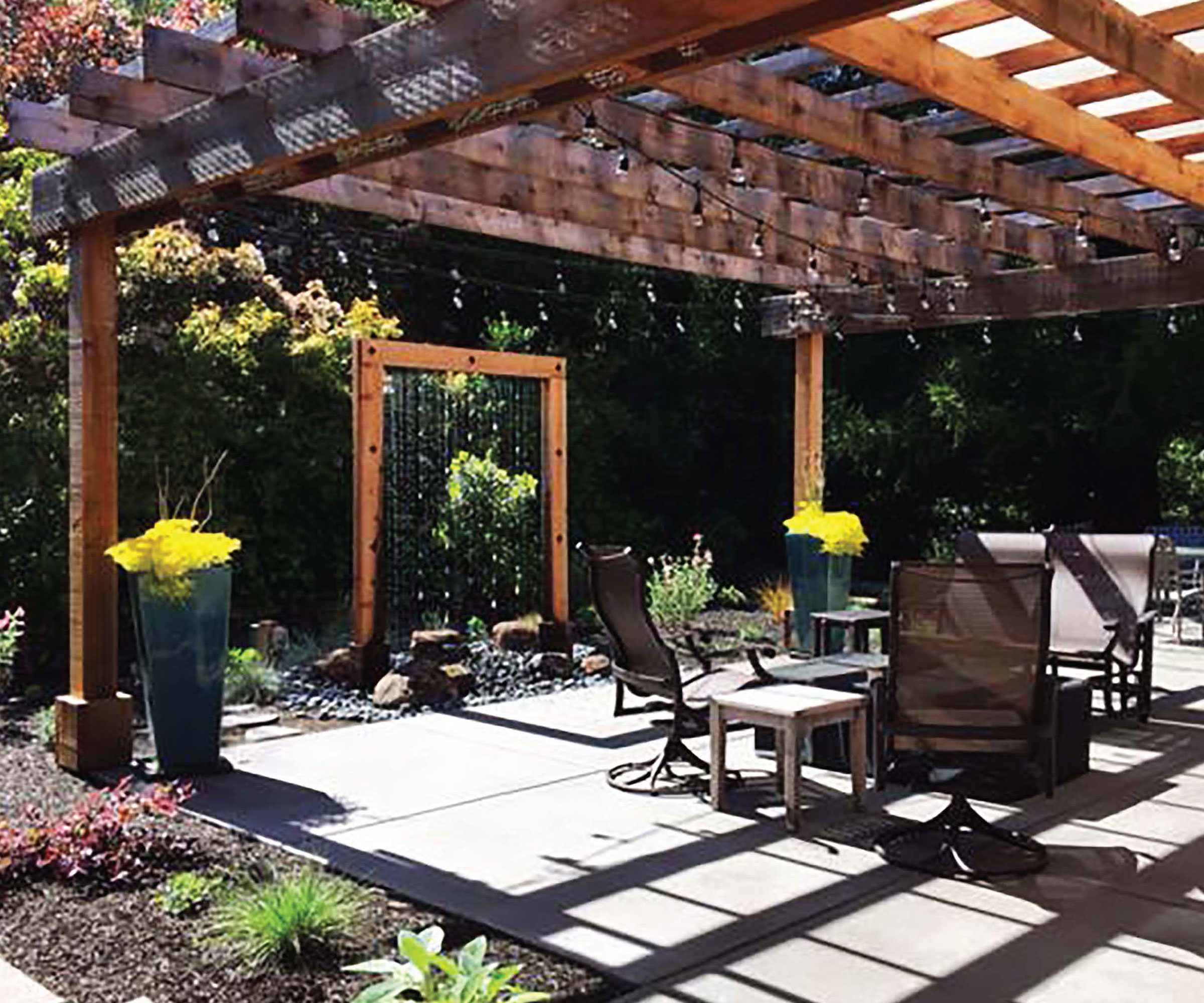 pergola design with patio, water feature, garden furniture, flowerbed and trees