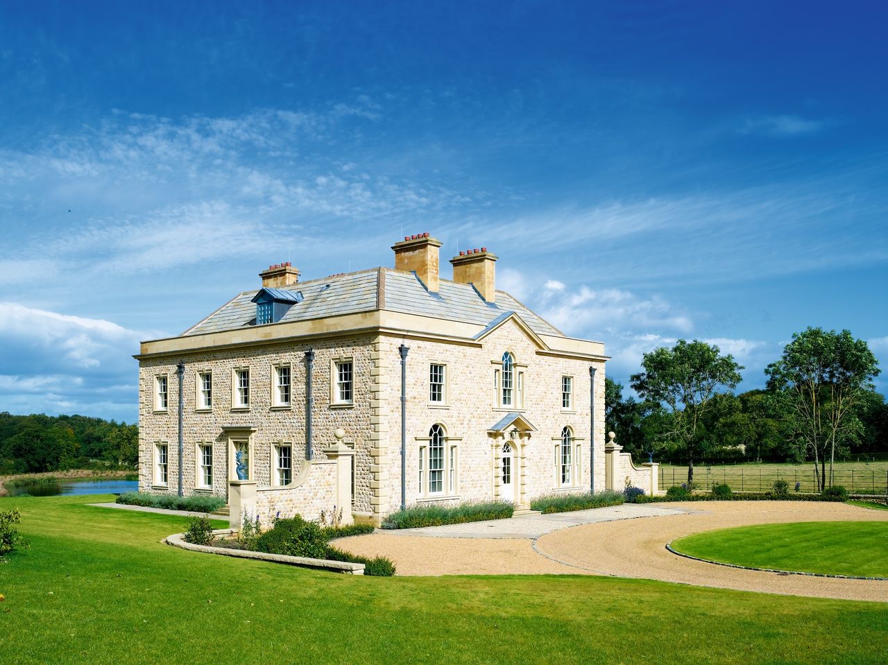 large georgian style self build with large gravel driveway