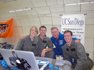 NASA astronaut Mike Fossum poses for a snapshot with the UC San Diego Microgravity Team during a weightless research flight with NASA's Microgravity University on July 19, 2013.