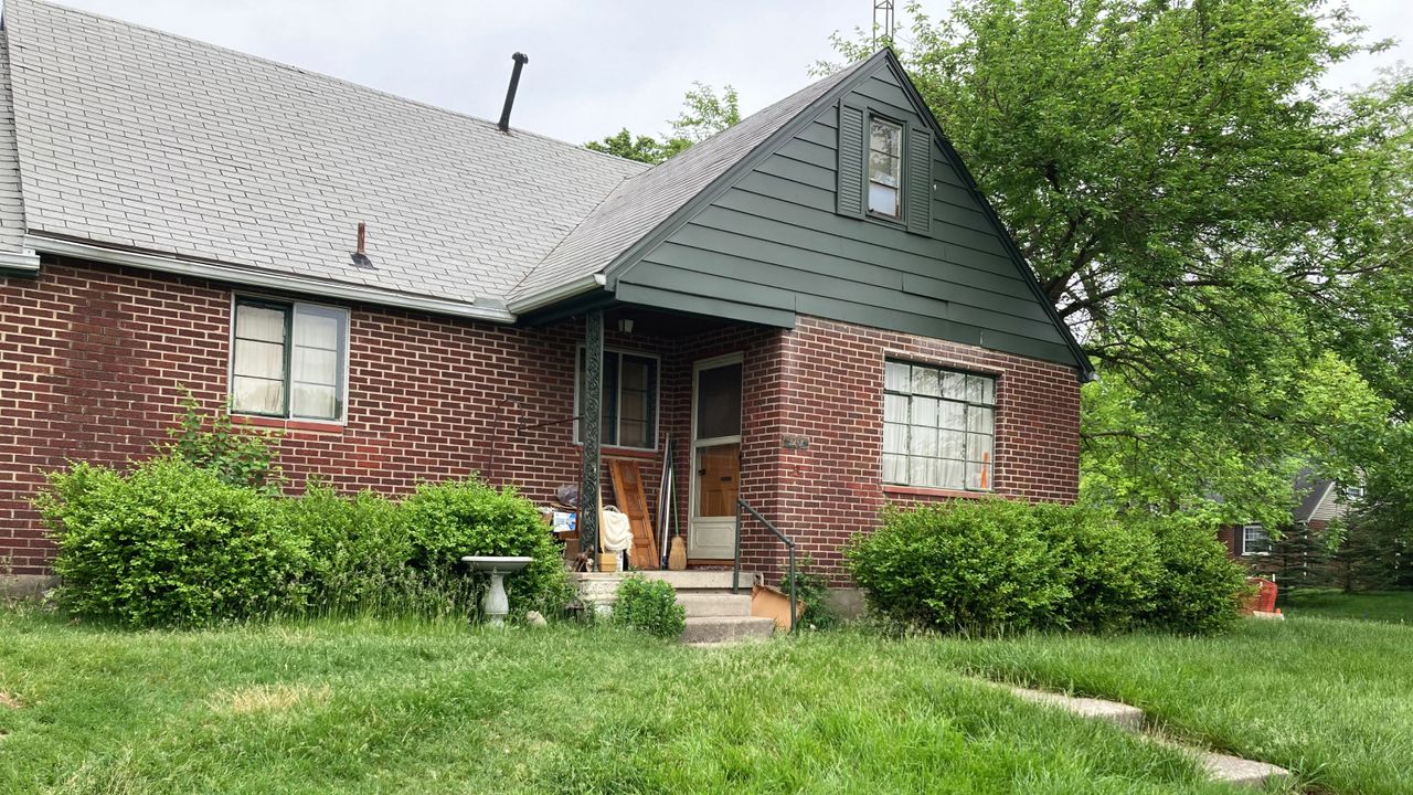 Overgrown front yard and house