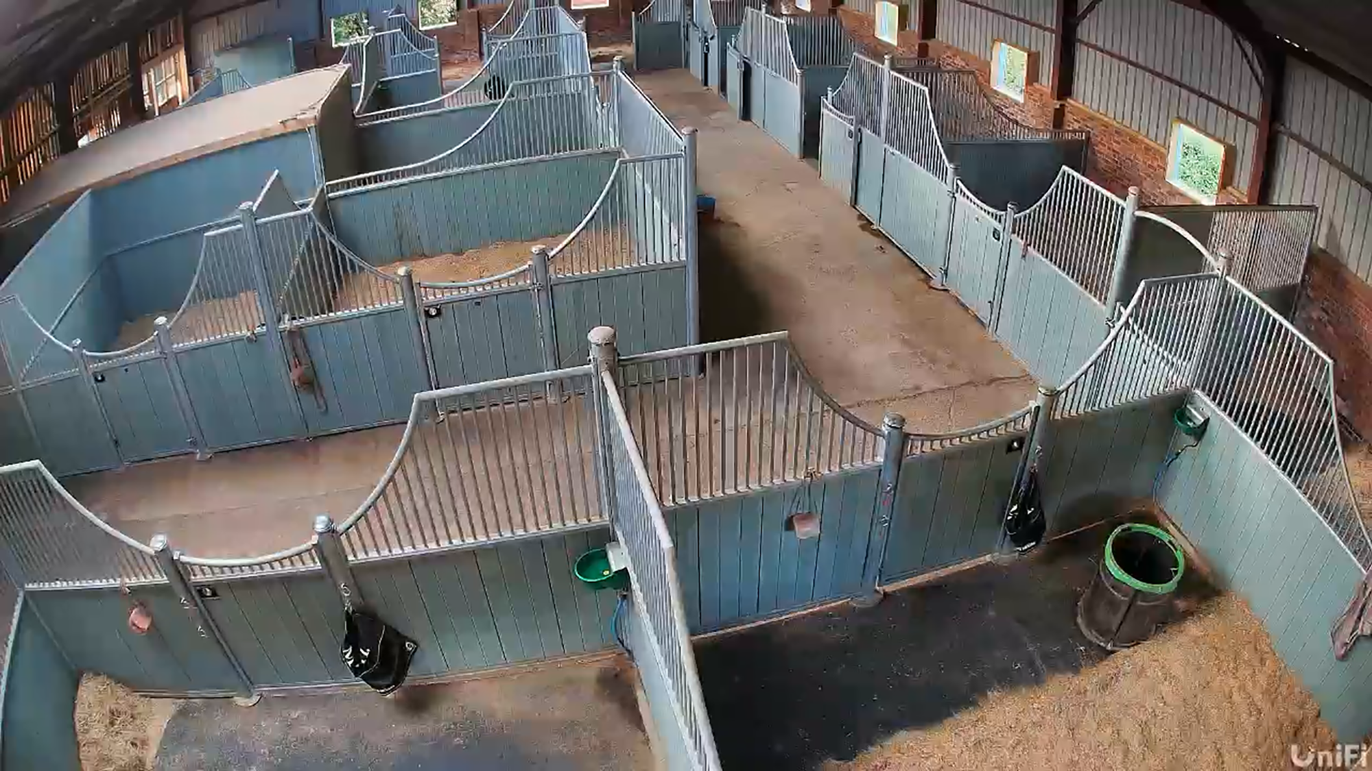 An overhead view of Miri Hackett's indoor barn stabling showing the wide walkways and curved partitions that allow horses to interact.