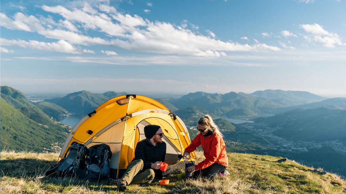 A couple camping on a mountain top