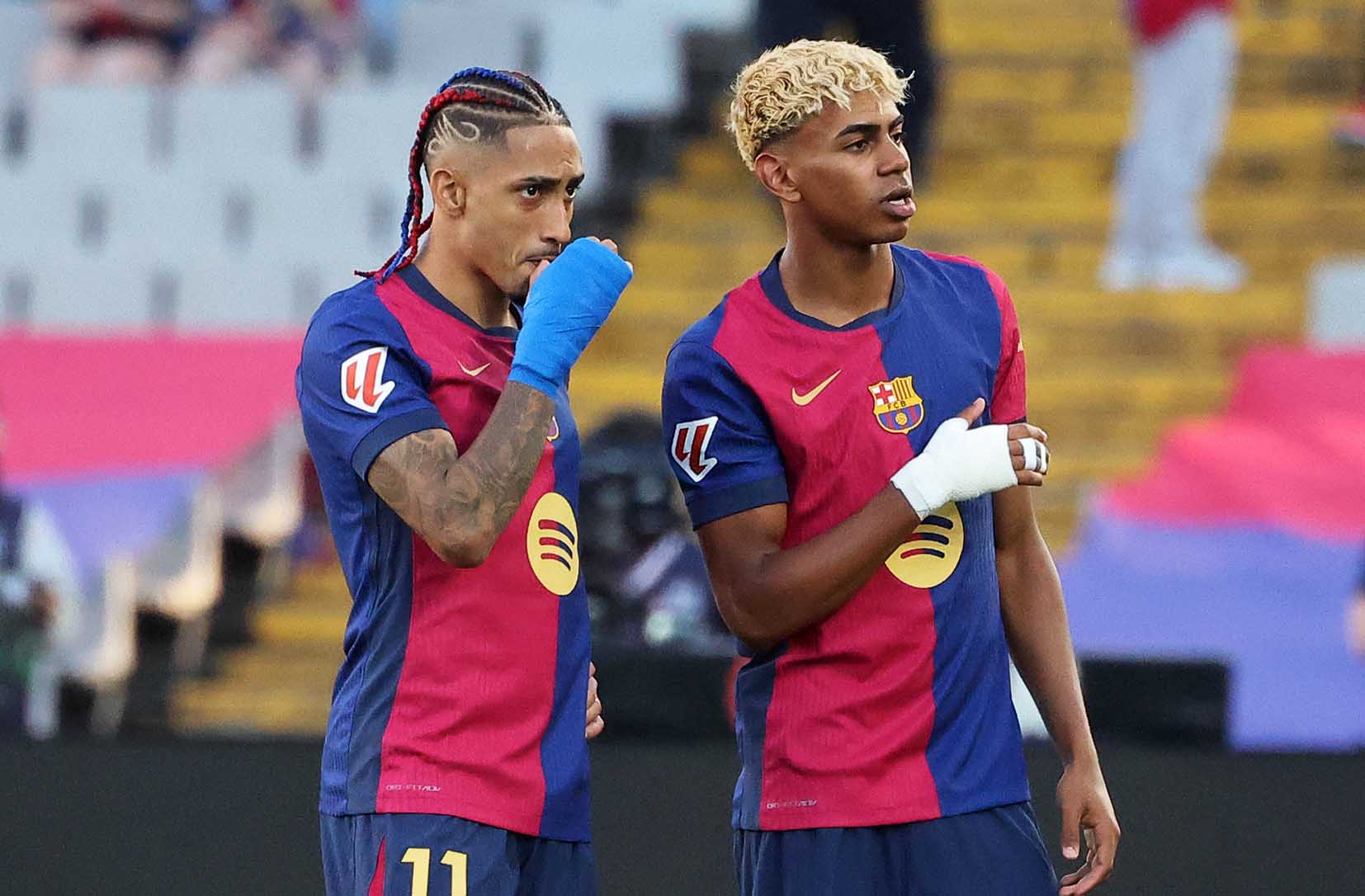 Spain prodigy Lamine Yamal (R) alongside Brazilian winger Raphinha (L)