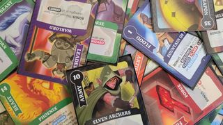 A collection of cards from Fantasy Realms Deluxe piled on top of one another