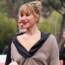 Jennifer lawrence wears a black and tan top.