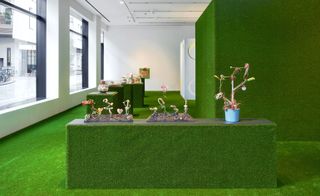 London gallery carpeted wall-to-wall with green grass carpet