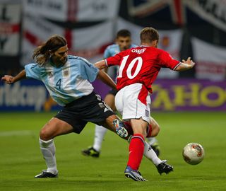 Michael Owen (No.10) of England is tackled in the penalty area by Mauricio Pochettino (No.4) of Argentina during the England v Argentina, Group F, World Cup Group Stage match played at the Sapporo Dome in Sapporo, Japan on June 7, 2002. England won the match 1-0.