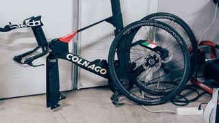 A Colnago time trial bike without its front wheel on the floor