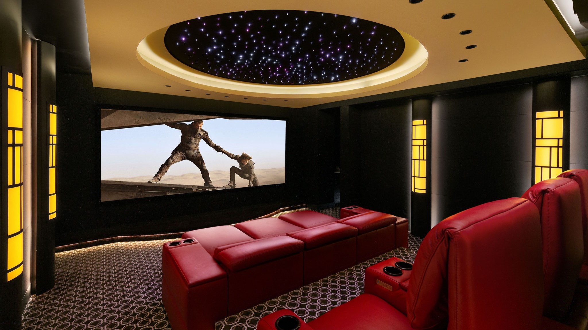 Home theater space with red seating and screen showing Dune 2