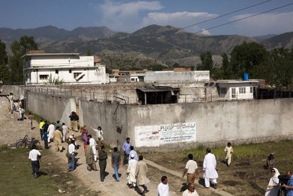 Pakistanis gather outside of Osama bin Laden's Abbottabad compound one day after his death.