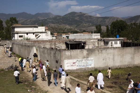 Pakistanis gather outside of Osama bin Laden&amp;#039;s Abbottabad compound one day after his death.