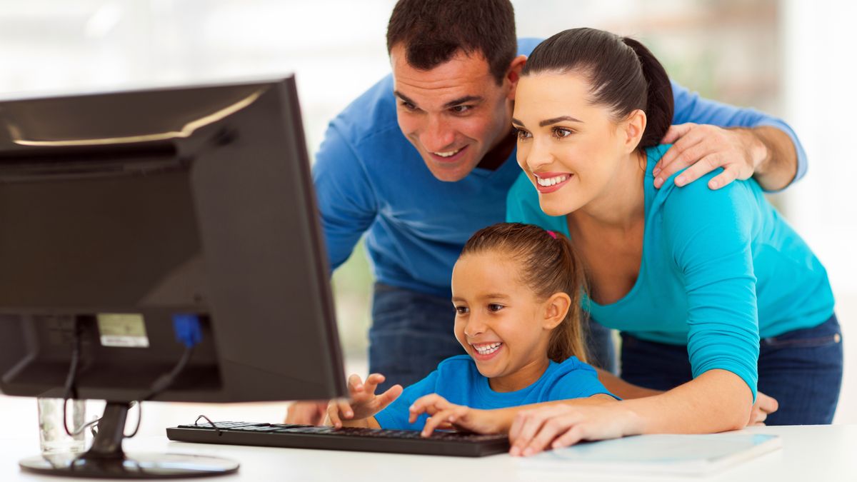 A family using a PC and looking at the monitor