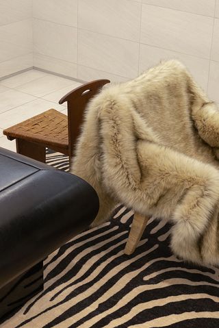 Beige fluffy throw over a wooden chair