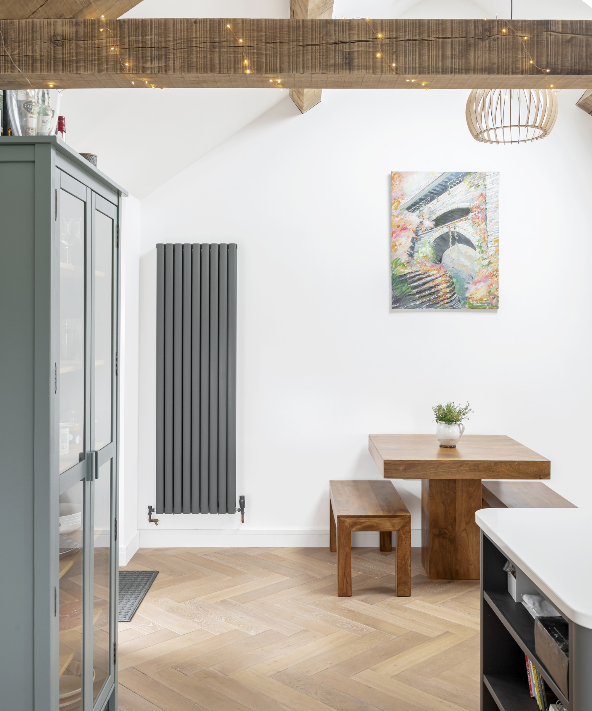 inside of barn conversion with grey vertical radiator on wall