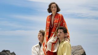 Ana de Armas being carried by Felix Kammerer and Toby Wallace in Eden