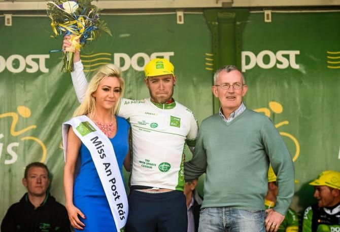 Christopher Lawless (Great Britain National Team) is presented with the Under 23 jersey by Miss An Post R&aacute;s Ruth McCourt, left, and Martin Blige after Stage 1