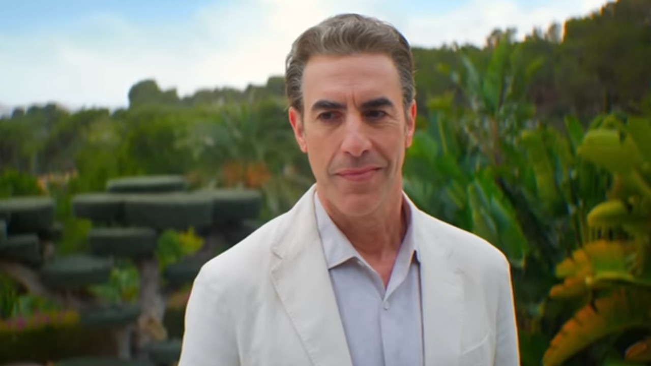Sacha Baron Cohen cocky smile in Ladies First.