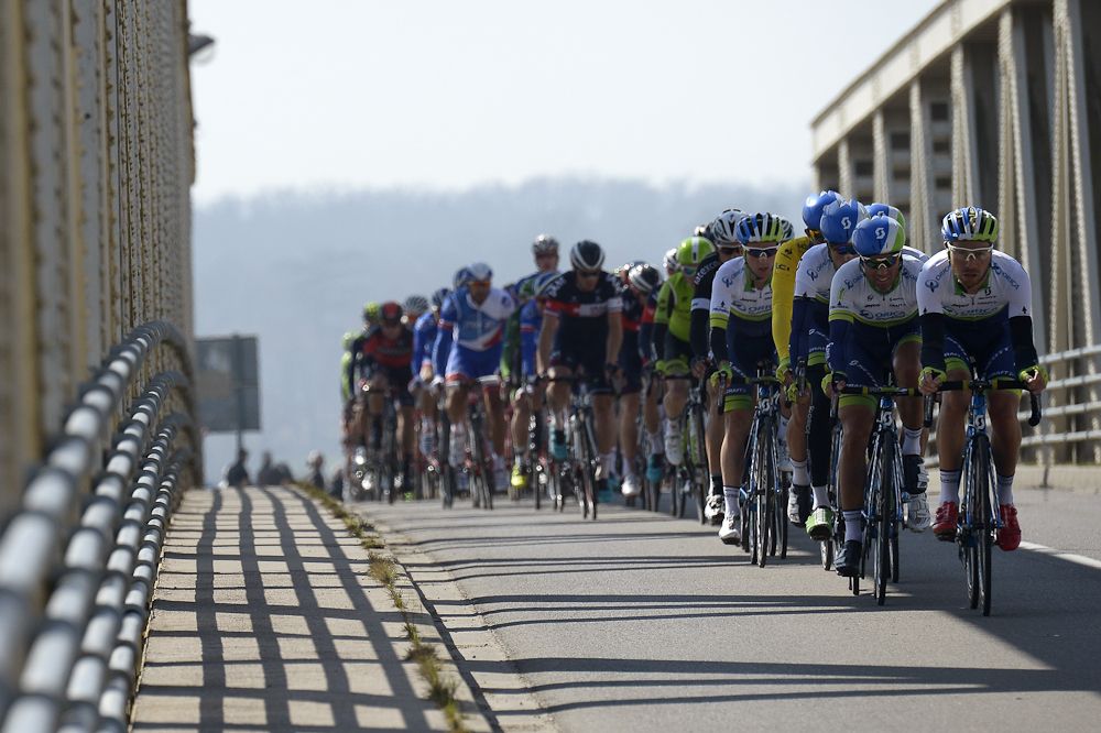 The pack rides on a bridge during the fourth stage of the 73rd edition of the Paris-Nice.