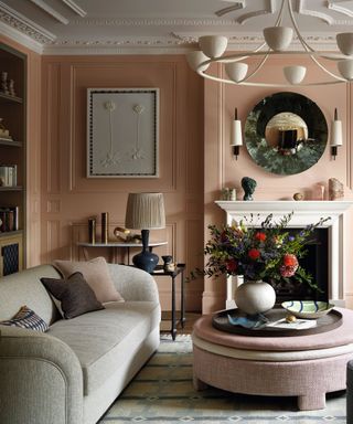 living room with pink walls and plaster detail