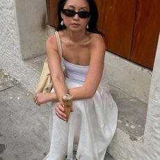 woman in white linen skirt and tube top