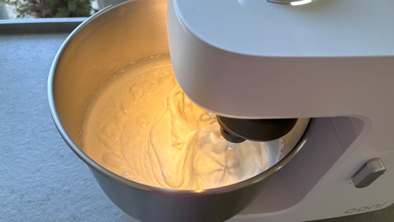 Testing the Ooni Halo Core Stand Mixer showing the whisk whipping cream
