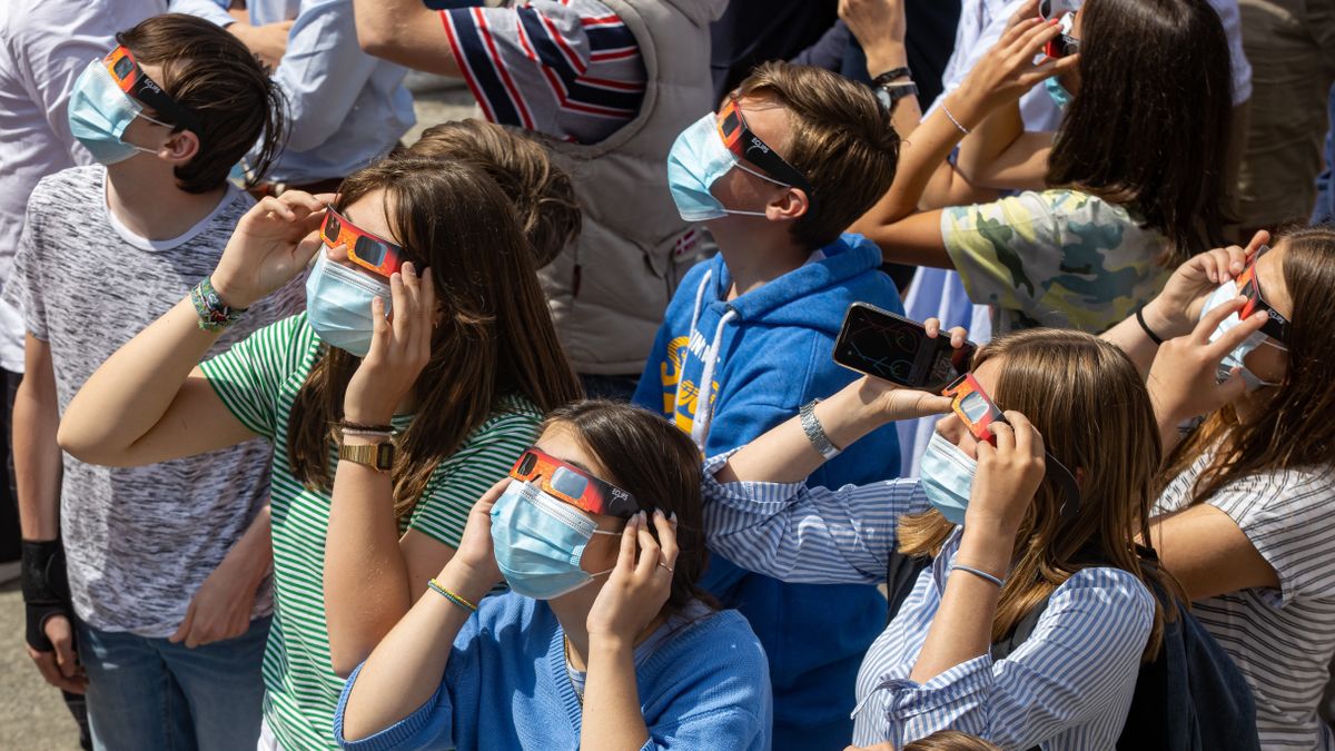 Students in Belgium use eclipse glasses to observe the partial solar eclipse on June 10, 2021, as photographed by Kurt Desplenter.