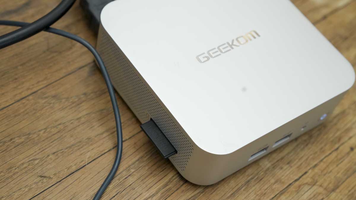 Geekom A7 mini PC on a desk in a home office