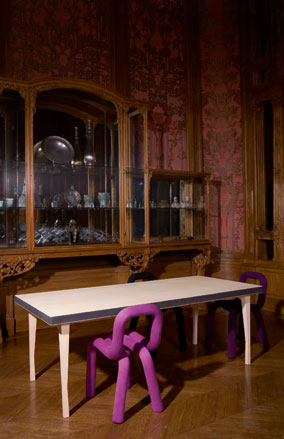 Modern pink chair at white table