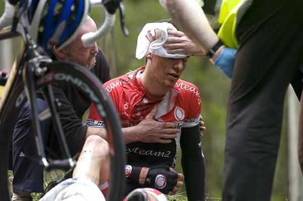 Alexander Smyth (Search2Retain-My Team2)is attended to by tour medical staff after crashing on a slippery winding section of stage three.