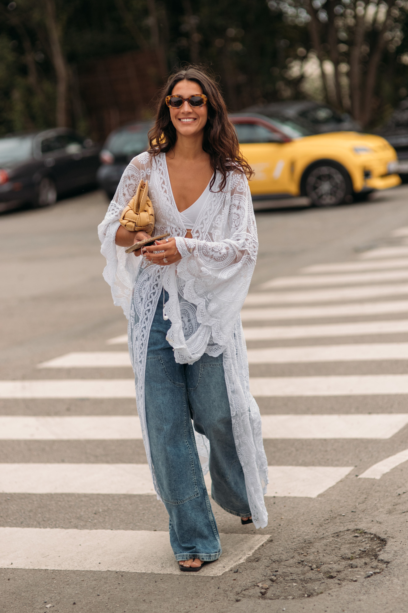 woman wearing a white lace duster and jeans