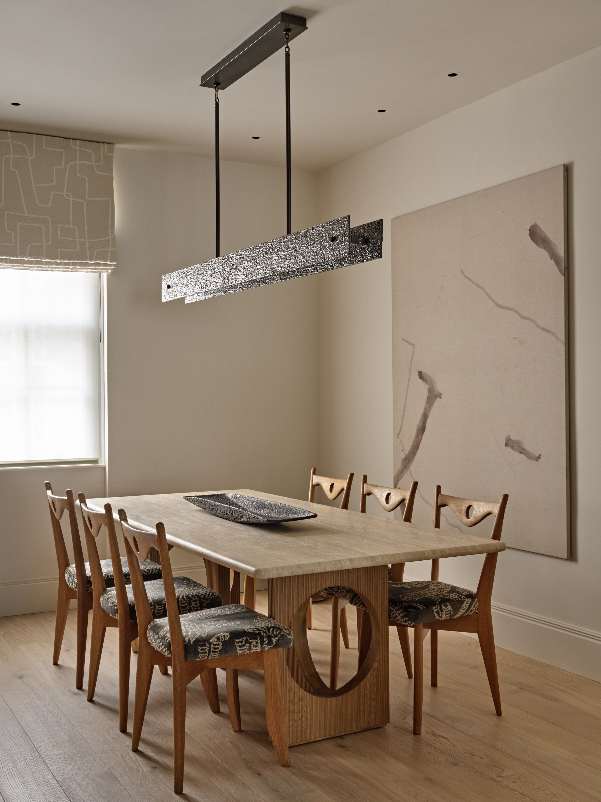 Beige dining room with wood chairs and table